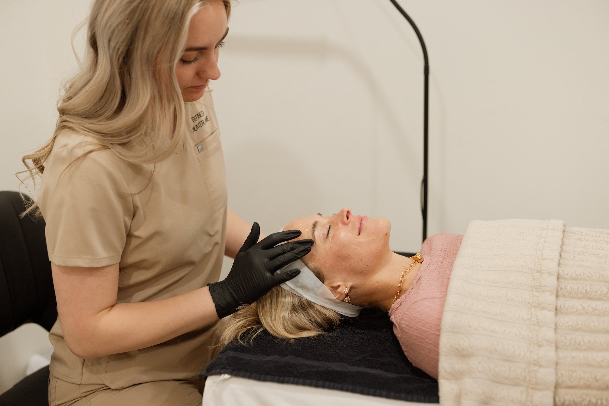 Esthetician performing microneedling treatment at Berkana BodyWorks